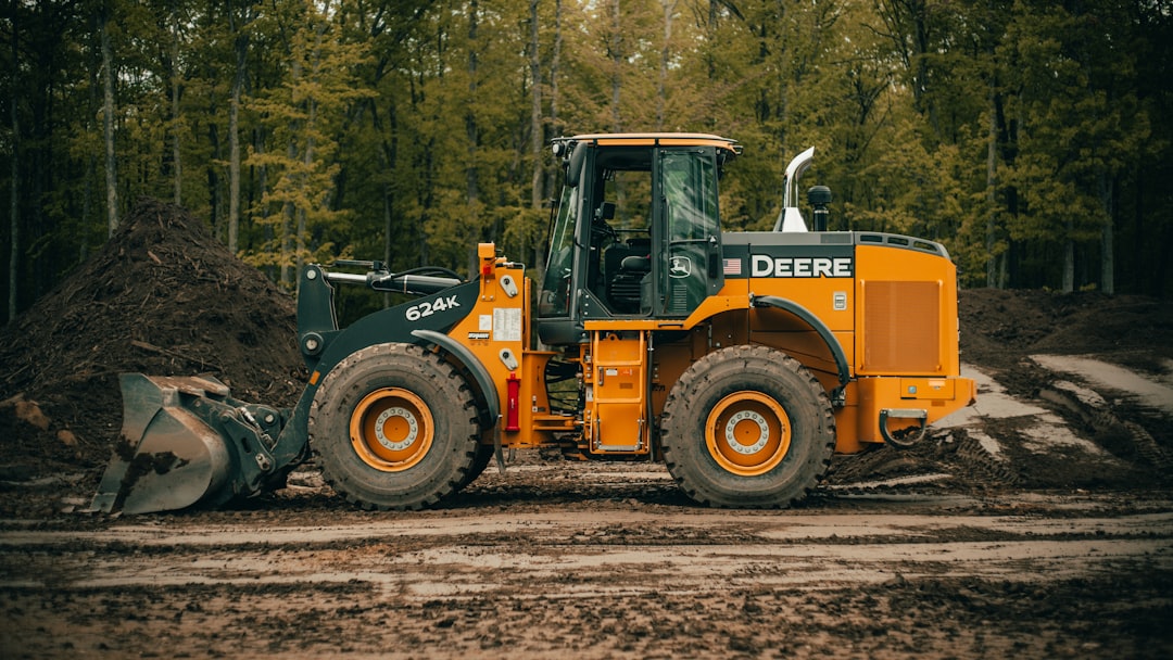 our-services-01 a-tractor-is-parked-in-the-dirt-near-a-pile-of-dirt-kormf1nz8iw